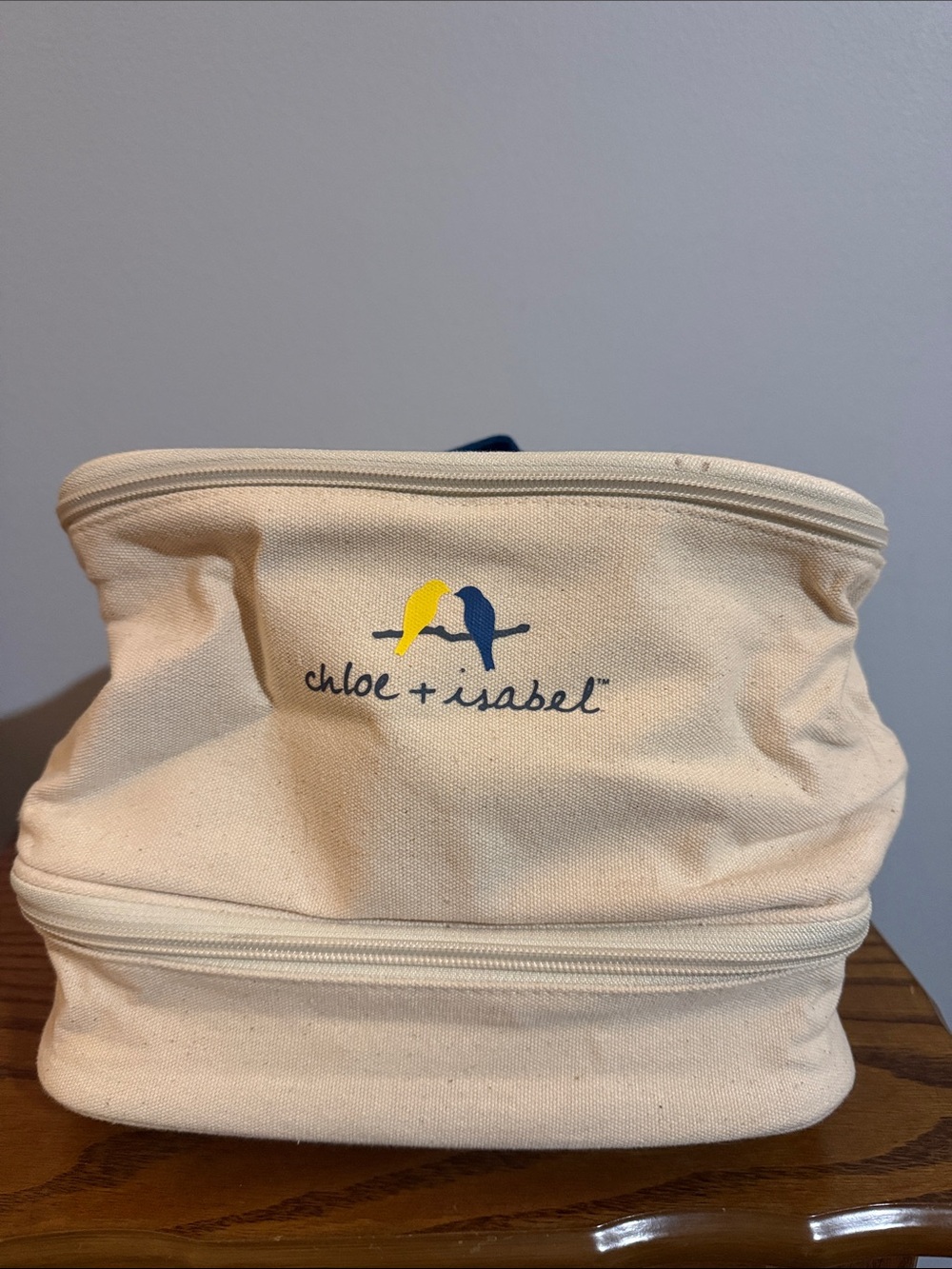 Chloe + Isabel Cream Canvas Cosmetic Pouch with Yellow & Navy Bird Logo